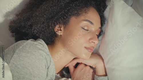 Wallpaper Mural Peaceful African American woman resting on white pillow with hands under her cheek. Sleeping calmly while lying sideways and embracing comfort of soft bedding in gentle natural light. Torontodigital.ca