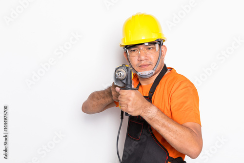 portrait worker in black uniform with electric drill isolated on white background