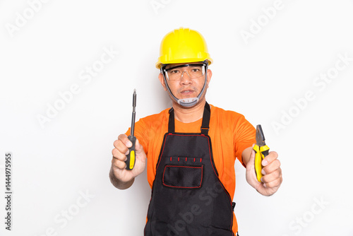 Portrait worker in black uniform with screwdriver and pliers isolated on white background.