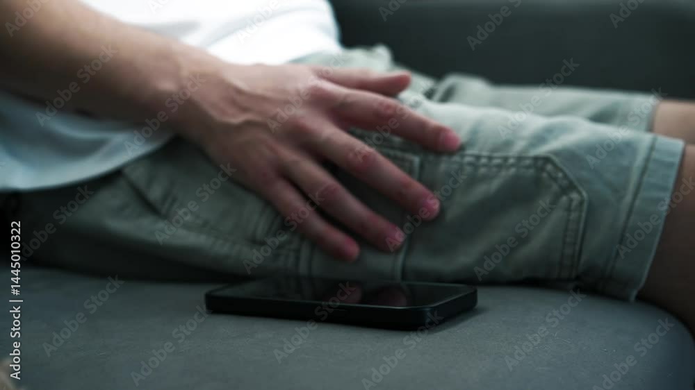 A business man sits on a sofa with a mobile phone.
The man received a call on his mobile phone and he picked up the phone.
The man looks at the time on his phone.
Modern gadget A business man sits on a sofa with a mobile phone.
The man received a call on his mobile phone and he picked up the phone.
The man looks at the time on his phone.
Modern gadget