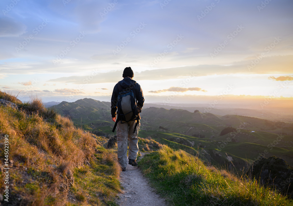 Hiking Te Mata Peak. Setting sun casting a warm glow on rolling hills. Hawke’s Bay.