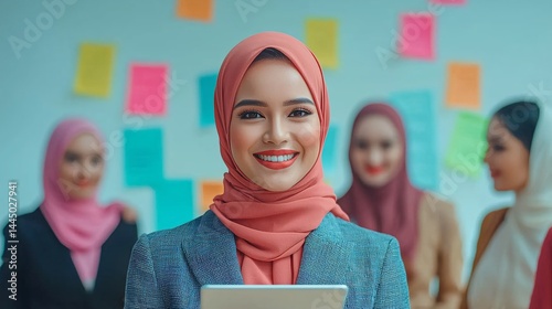 Confident Woman in Headscarf Holding Tablet in Office Setting