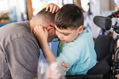 Disabled child showing affection to father during mealtime