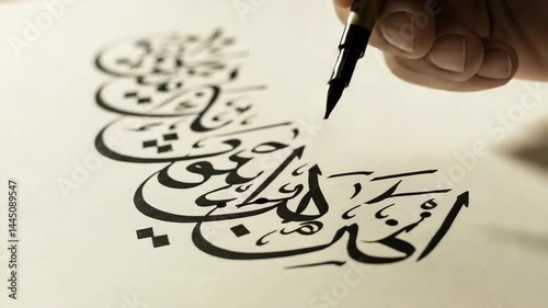 Close-up of Hand Writing Elegant Arabic Calligraphy