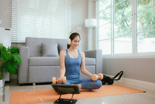 Confident young Asian woman practices yoga at home on exercise mat, embracing wellness, balance, and fitness through online training Free Download Confident young Asian woman practices yoga at home on exercise mat, embracing wellness, balance, and fitness through online training - GFXLoad