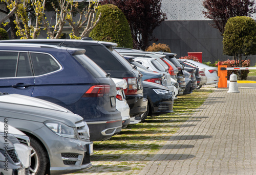 Cars are parked in an orderly manner in an open area parking lot
