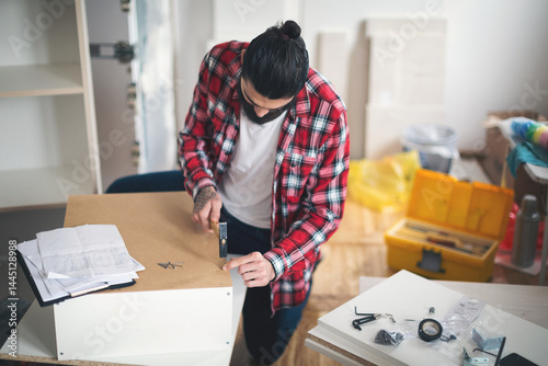Young man making his own furniture at home