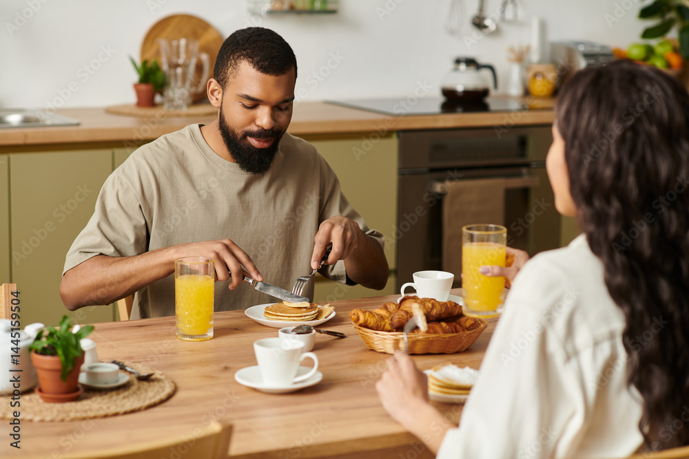 Joyful couple enjoys cozy breakfast together in their warm and inviting kitchen Joyful couple enjoys cozy breakfast together in their warm and inviting kitchen