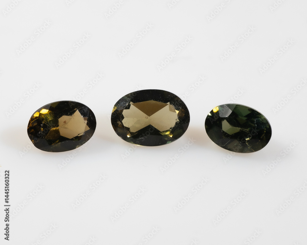 Three Faceted Oval Olive Green Gemstones on White Background