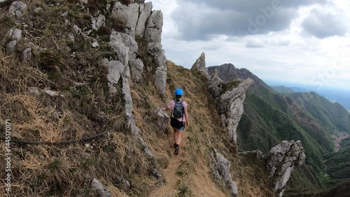 A climber prepares for Cresta Giumenta’s next exposed section surrounded by the Orobie prealps mountains of the province of Bergamo and Lecco