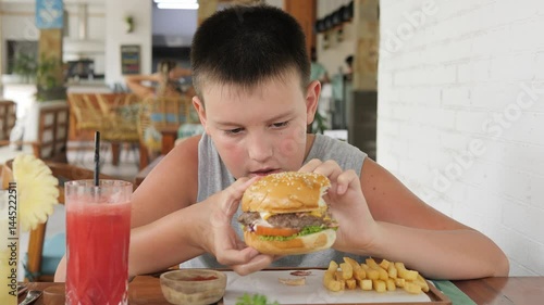 Child sitting in cafe eating fast food reflects modern lifestyle Scene shows how fast food shapes habits emotions and daily routine Focus on culture of fast food and impact of such food choices