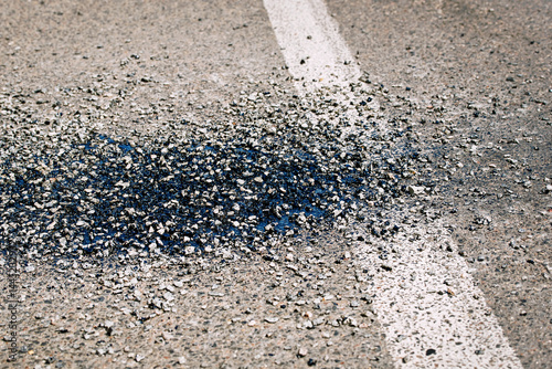 Obraz na płótnie Close view of road construction maintenance using gravel, bitumen, and resin to repair cracked asphalt surface with fresh patch sealing urban pavement damage. Street maintenance process with patchwork w salonie