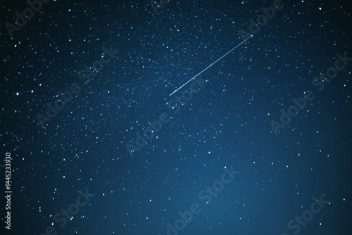 A shooting star streaks across a tranquil night sky filled with a myriad of sparkling stars.