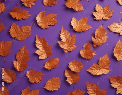 Dry orange metallic leaves scattered on a violet background, creating a textured autumnal pattern , botanical, october