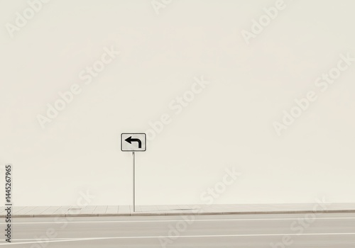 Obraz na płótnie White rectangular turn left road sign symbol stands on a metal pole next to a sidewalk on a city street with an empty light wall background. w salonie