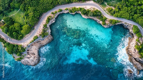 Coastal road winds around a turquoise cove