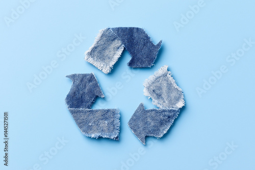 recycling symbol made from denim on blue background
