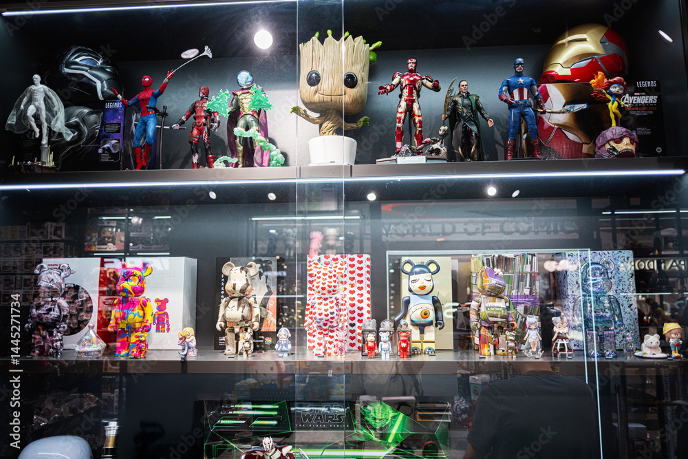Naklejka premium Display case featuring action figures, collectible toys, and comic character statues