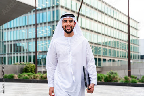 Arab middle-eastern man wearing emirati kandora traditional clothing in the city
