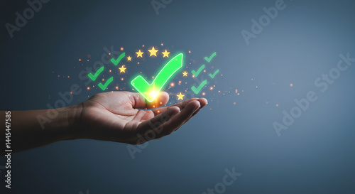 A hand holding a glowing green check mark with stars and smaller check marks floating around it on blue background