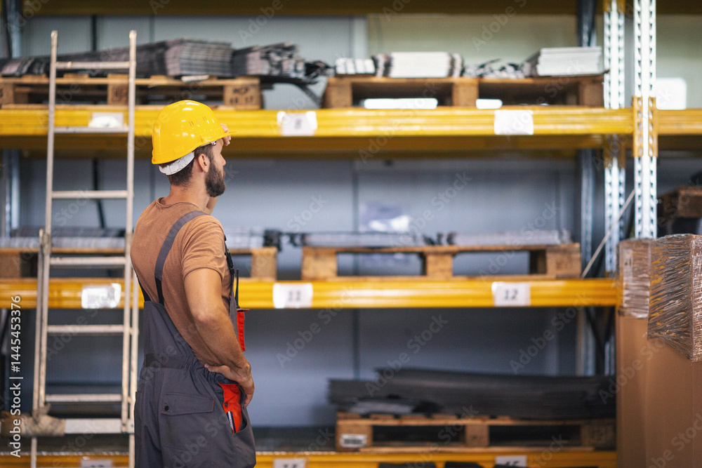 Young worker in the warehouse checking stuff Young worker in the warehouse checking stuff