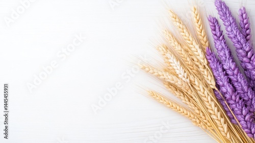 A bunch of golden wheat and purple lavender flowers arranged together, minimalist composition on white background, and natural and rustic elements.