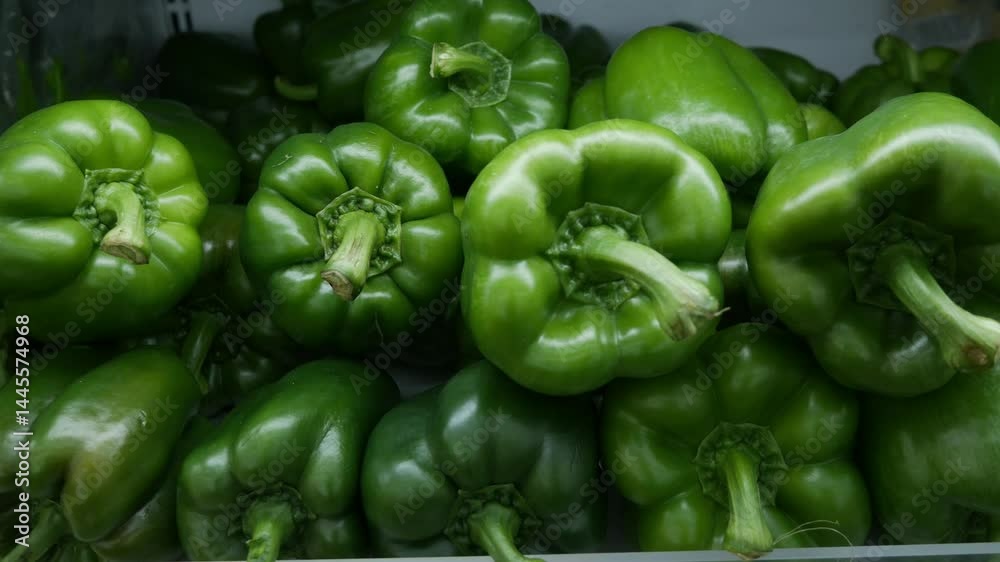 Green Bell peppers (capsicum) on supermarket shelf. Green Bell peppers (capsicum) on supermarket shelf.