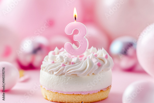Small birthday cake with a lit number three candle