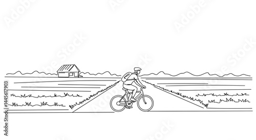 Person cycling through a rural landscape with fields and a barn  