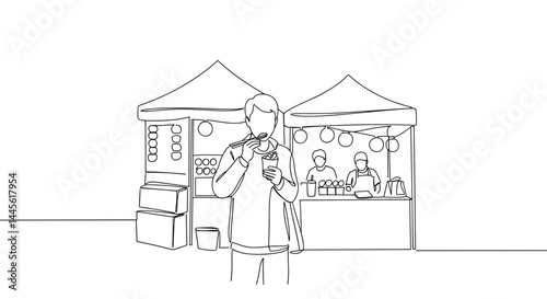 Person enjoying refreshing drink at busy market stalls  