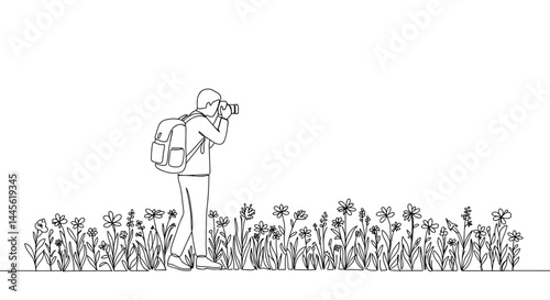 Person photographing flowers in a nature setting  