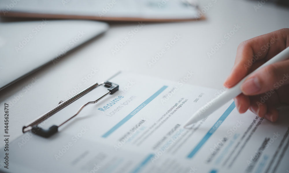 People are reviewing job applications before filling out their resume on the job application form in order to apply for a job at a company. People are reviewing job applications before filling out their resume on the job application form in order to apply for a job at a company.