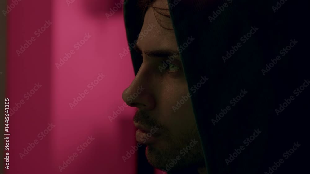 Close up of male hacker in hooded jacket typing on laptop computer keyboard and cracking passwords. Dangerous computer hacker in hooded jacket infecting system with cyber virus. Close up of male hacker in hooded jacket typing on laptop computer keyboard and cracking passwords. Dangerous computer hacker in hooded jacket infecting system with cyber virus.