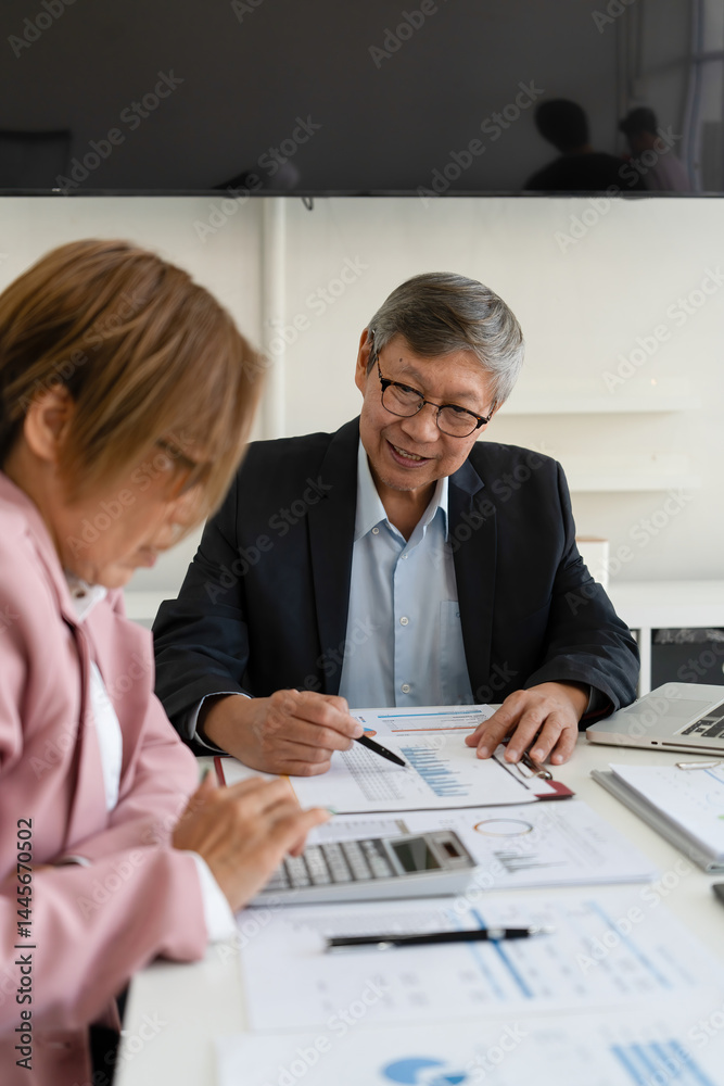 Obraz premium Senior businessmen calculating investment.