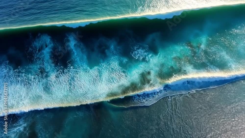 Aerial View of Turquoise Ocean Waves Crashing on Sandy Shoreline