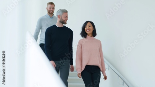 Group of friends walking together in a modern, well-lit staircase during a vibrant afternoon.