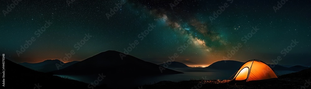 Illuminated camping tent under the mesmerizing night sky with stars above