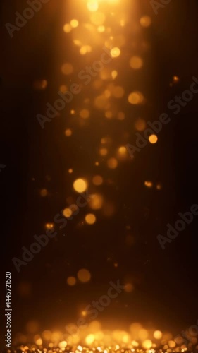 A gold glitter background with a light shining down