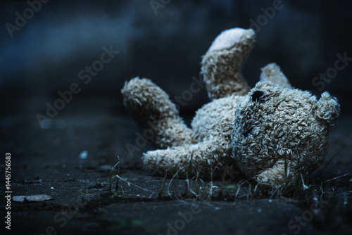 Obraz na płótnie Conceptual image: lost childhood loss future, loneliness, pain and depression. Dirty toy Teddy bear lying down outdoors. Copy space. w salonie