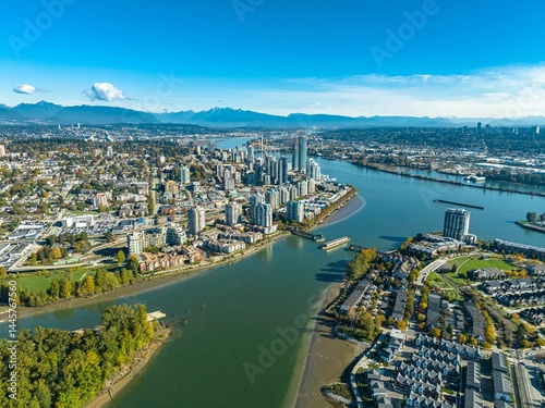 Fototapeta Naklejka Na Ścianę i Meble -  Aerial view of New Westminster skyline along Fraser River