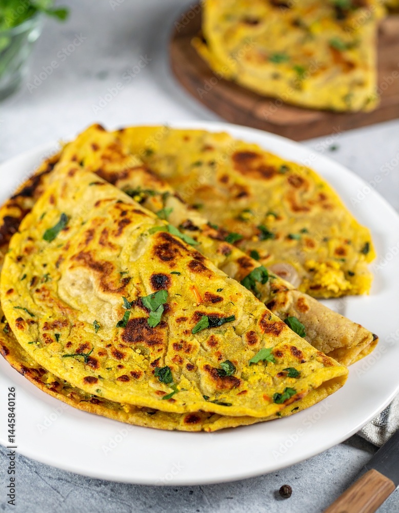 Homemade wheat paratha stuffed colliflower and onion. Gobi Paratha cutted into pieces, close up. Homemade wheat paratha stuffed colliflower and onion. Gobi Paratha cutted into pieces, close up.