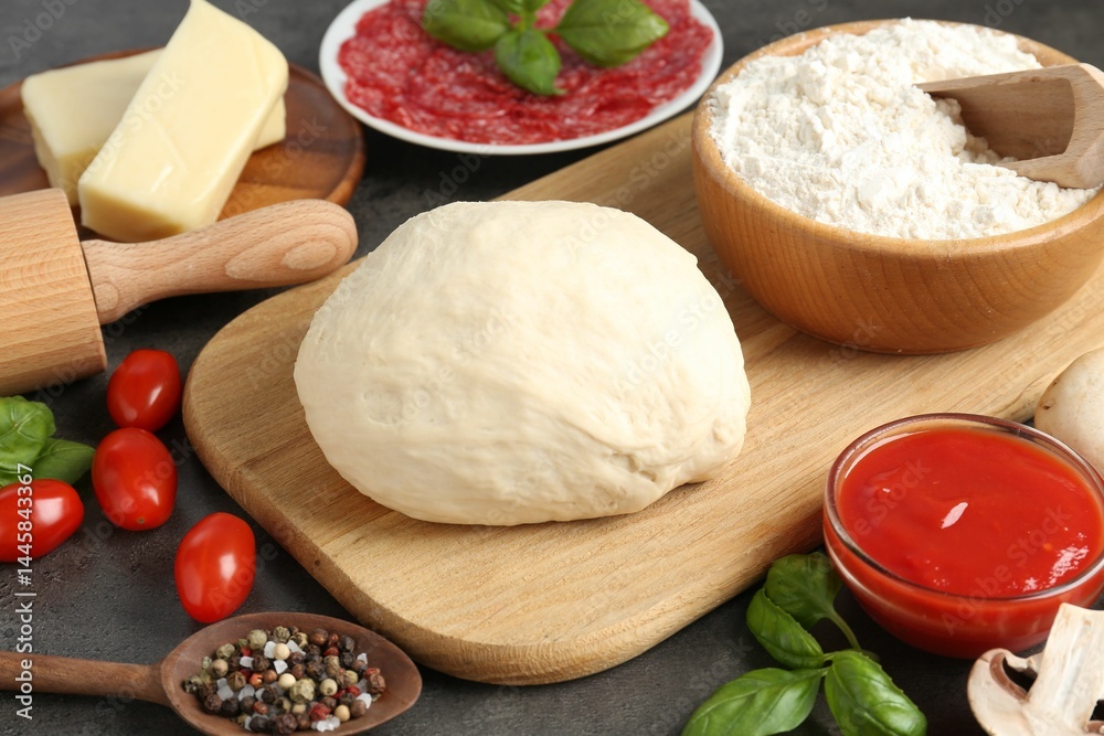 Making pizza. Different ingredients on gray textured table, closeup Making pizza. Different ingredients on gray textured table, closeup