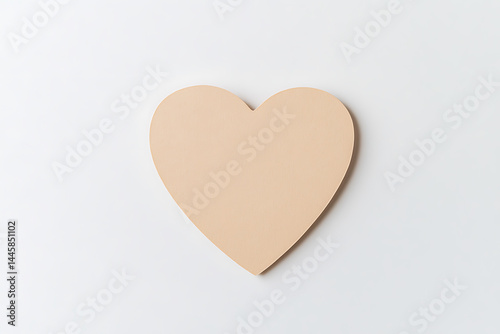 Beige heart isolated on a bright white backdrop. Simple, elegant, and minimalist in design. Evokes sentiments of love, warmth, and tenderness.