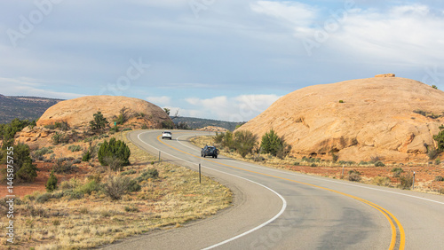 Travelers cruise along a desert highway en route to the breathtaking landscapes of Canyonlands National Park