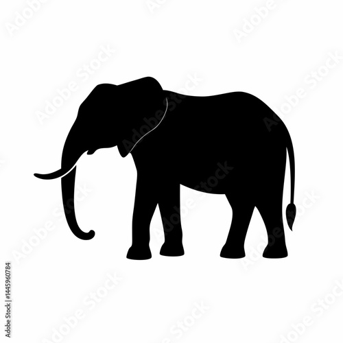 Silhouette of a black elephant with tusks and trunk raised