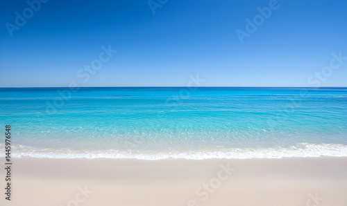 Beach scene. Azure sea meets sandy shore under a clear blue sky, creating a serene coastal landscape