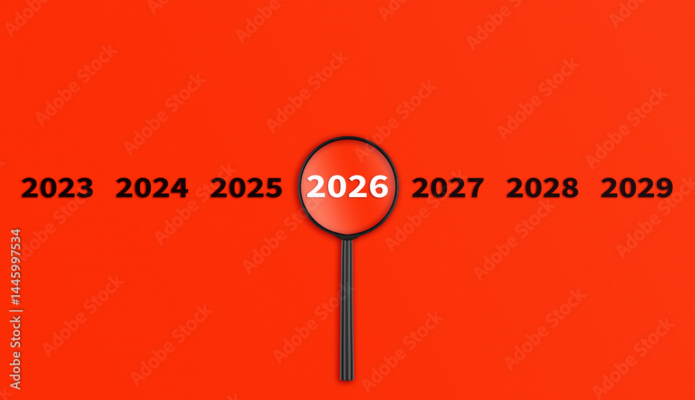 Lens, magnifying glass focusing on the year 2026 on a red background. Financial or stock market strategies and past and future events.