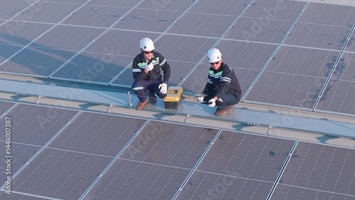 Engineers inspecting rooftop solar panels for maintenance