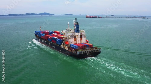 Large cargo ship transporting colorful containers across ocean
