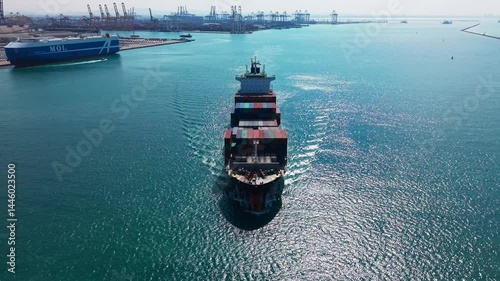 Large cargo ship transporting colorful containers across ocean